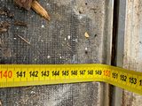a measuring tape on the ground next to a fire hydrant