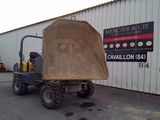 a picture of a dump truck parked in front of a building