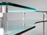 a glass table with a glass shelf on top of it