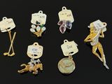 several different types of charms are displayed on a black surface