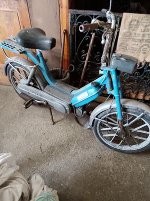 a blue scooter that is parked in a garage