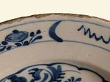 a blue and white plate with a design on it
