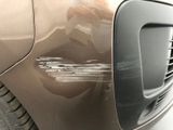 a close up of a car ' s front bumper with scratches on it