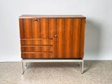 a close up of a cabinet with drawers on a carpeted floor