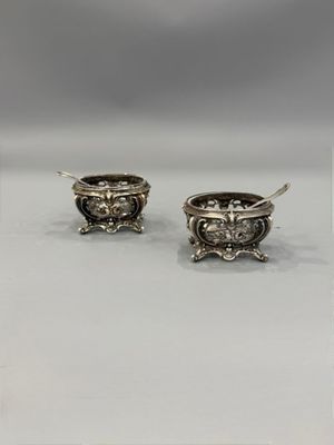 a pair of silver plated earrings with a lion head on them
