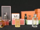several bottles of perfume sitting on top of a table next to boxes