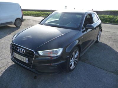 L'Audi noire est garée sur le parking, à côté d'une camionnette.