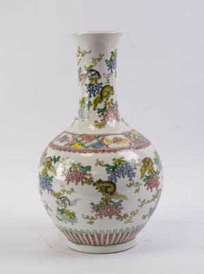 a white vase with flowers and birds on it