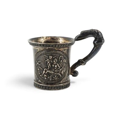 an old silver cup with a handle and a design on it