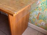 a wooden table with a glass top in a room