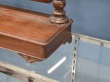 a glass display case with a wooden shelf on it