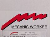 a sign that says mechanic worker on the side of a building