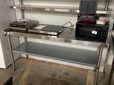 a kitchen with a stove, microwave, and other appliances in it