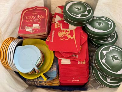 many plates and cups in a basket with a book