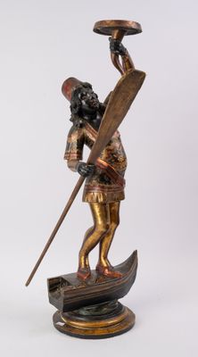 figurine en bronze représentant un homme dans un bateau, muni d'une pagaie