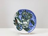 a small plate with a blue and green design on it