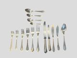 a lot of forks and spoons that are on the table