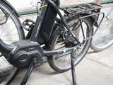 a bicycle that is parked next to a bike rack