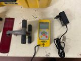 a yellow device that is sitting on a table next to other tools