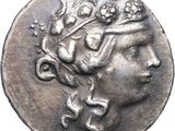 a close up of a coin with a woman ' s head on it