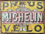 a sign that says michel vello on the side of a building