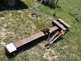 a rusted out trailer that is sitting in the grass