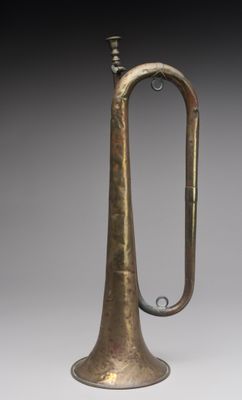 an old brass trumpet with a brass handle and a brass bell