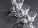 several empty wine glasses sitting on top of a table next to each other