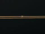 a gold necklace with a single diamond on it