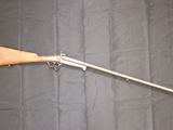 an old gun with a wooden handle on a black background