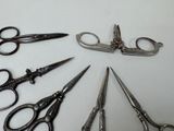 several pairs of scissors are arranged in a circle on a table