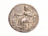 une vieille pièce d'argent représentant une femme à cheval et un homme à cheval
