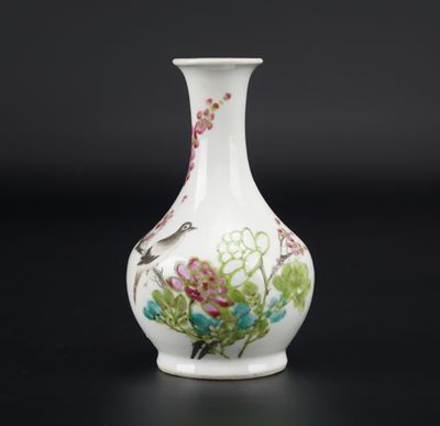 a white vase with flowers and birds painted on it