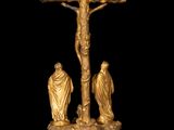 an image of a gold statue of jesus on a cross