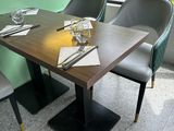 tables and chairs in a restaurant with a view of the street