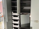 a large open cabinet with drawers in the middle of the room