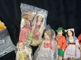 a lot of dolls in plastic bags on a black background