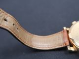 a close up of a wrist watch with a leather band