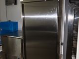a stainless steel refrigerator in the corner of a room