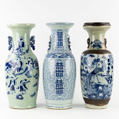 three blue and white vases sitting next to each other