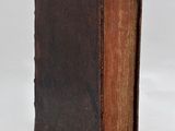 an old book sitting on top of a table next to a white background