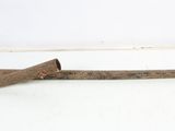 an old rusted iron pipe with a wooden handle on a white surface
