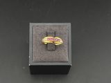 a close up of a ring in a box on a table