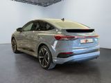 the rear end of a silver car parked in a showroom
