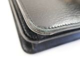 a close up of a wallet with a ring on it