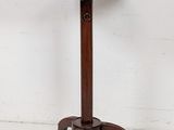 a round table with a metal top and wooden legs