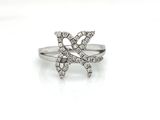 a close up of a diamond ring on a white surface