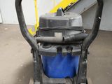 a blue and black vacuum sitting on the floor