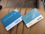 two books sitting on the back seat of a car next to a steering wheel