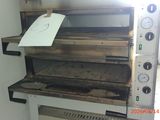 a large oven with a sign on top of it